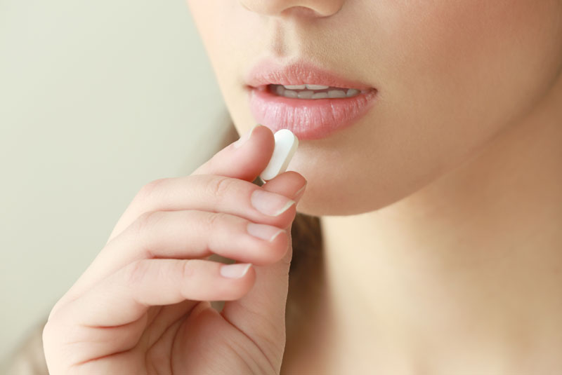 dental patient taking a sedative pill