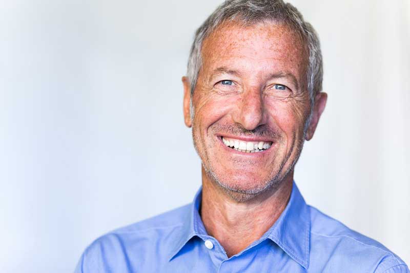 a patient smiling after his dental implant procedure