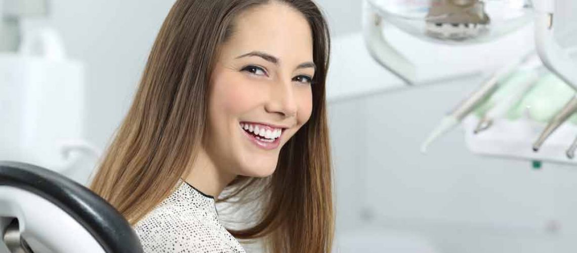 a dental patient smiling after her cosmetic treatment